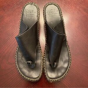 Andre Assous woman’s Black Leather Toe-Post Sandals